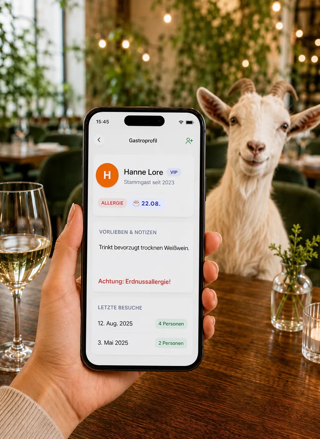 A smartphone shows a digital guest profile with loyalty, allergy and visit data in Bringmal’s online table reservation system; a goat sits in the restaurant